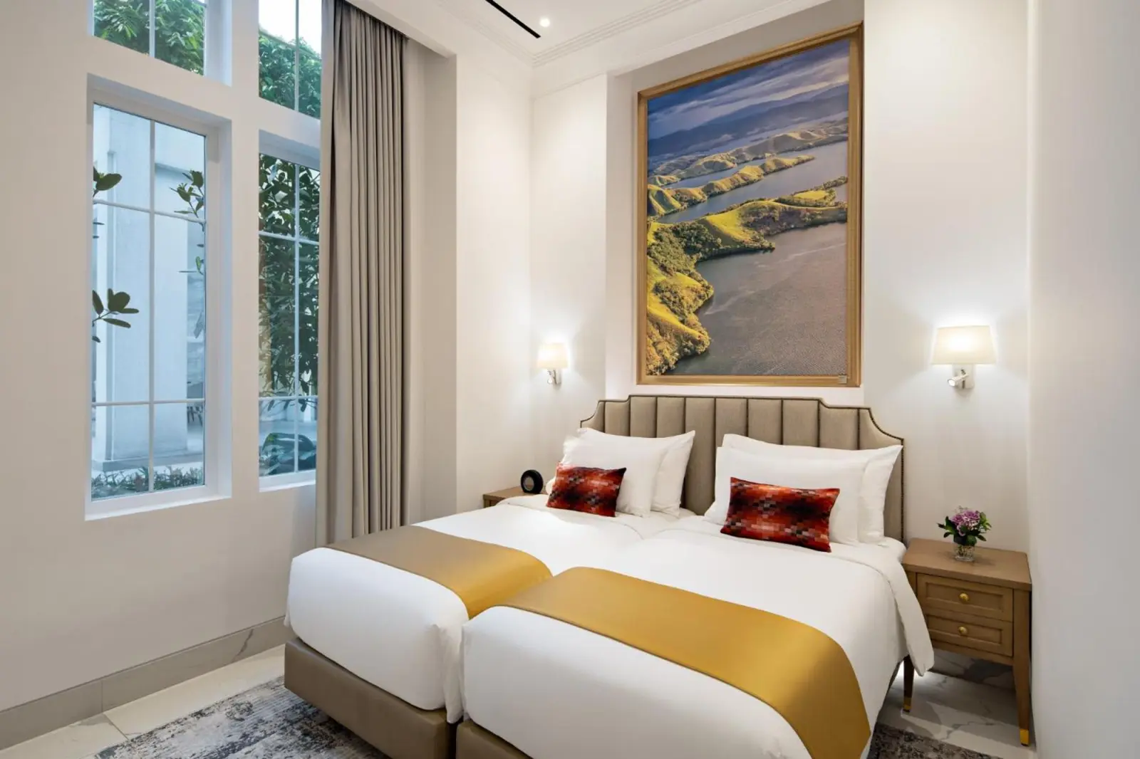 A luxurious twin bedroom at The Grand Mansion Menteng