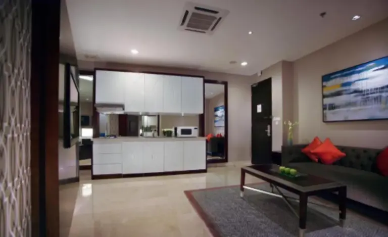The Grove Suites by Grand Aston Jakarta suite lounge with modern kitchenette and seating area