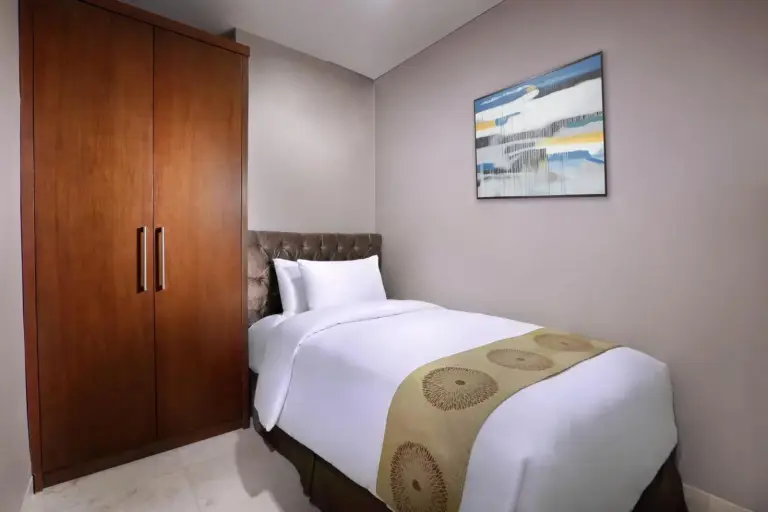 The Grove Suites by Grand Aston Jakarta single bedroom with wardrobe and minimalist decor