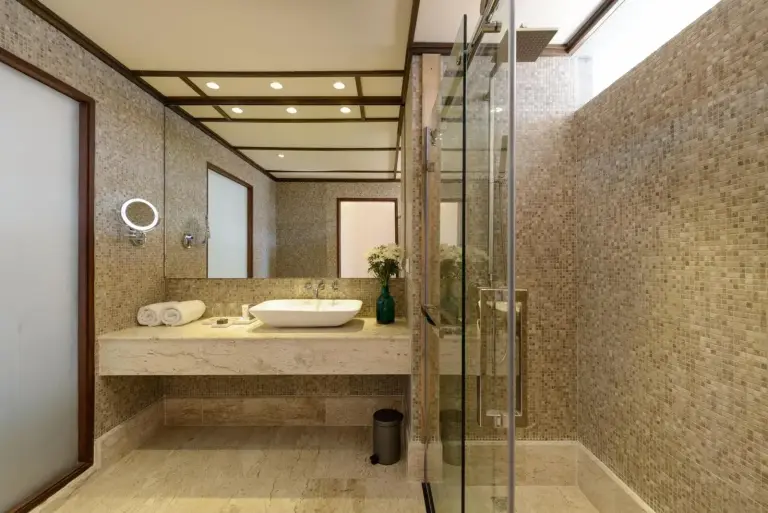 Modern bathroom at The Haven Khao Lak in Khao Lak with walk-in shower and vanity sink.