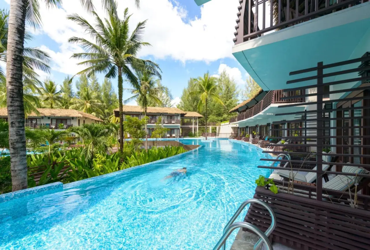 Infinity pool at The Haven Khao Lak in Khao Lak with palm trees and resort buildings in the background.