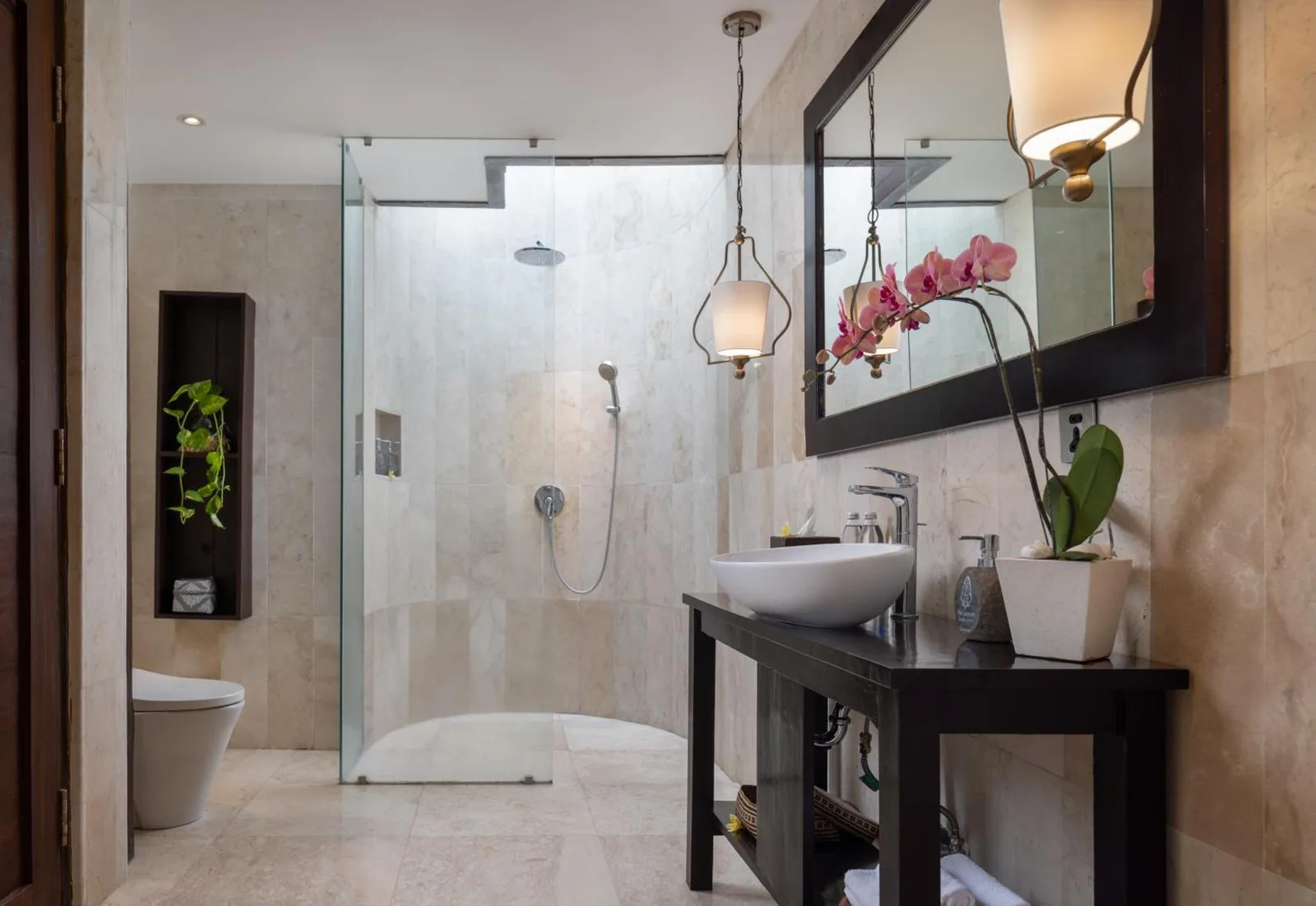 Modern shower area in a bathroom at The Kayon Valley Resort Ubud