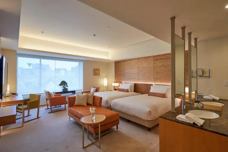 THE KITANO HOTEL TOKYO – Tokyo, Japan hotel – a hotel room with a bed and tables and chairs at THE KITANO HOTEL TOKYO in Tokyo