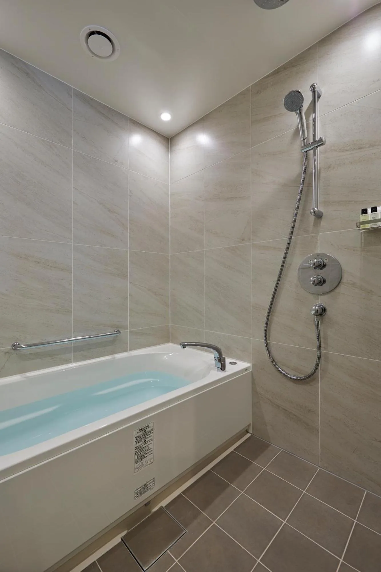 Bathroom with shower and bathtub at The Kitano Hotel Tokyo