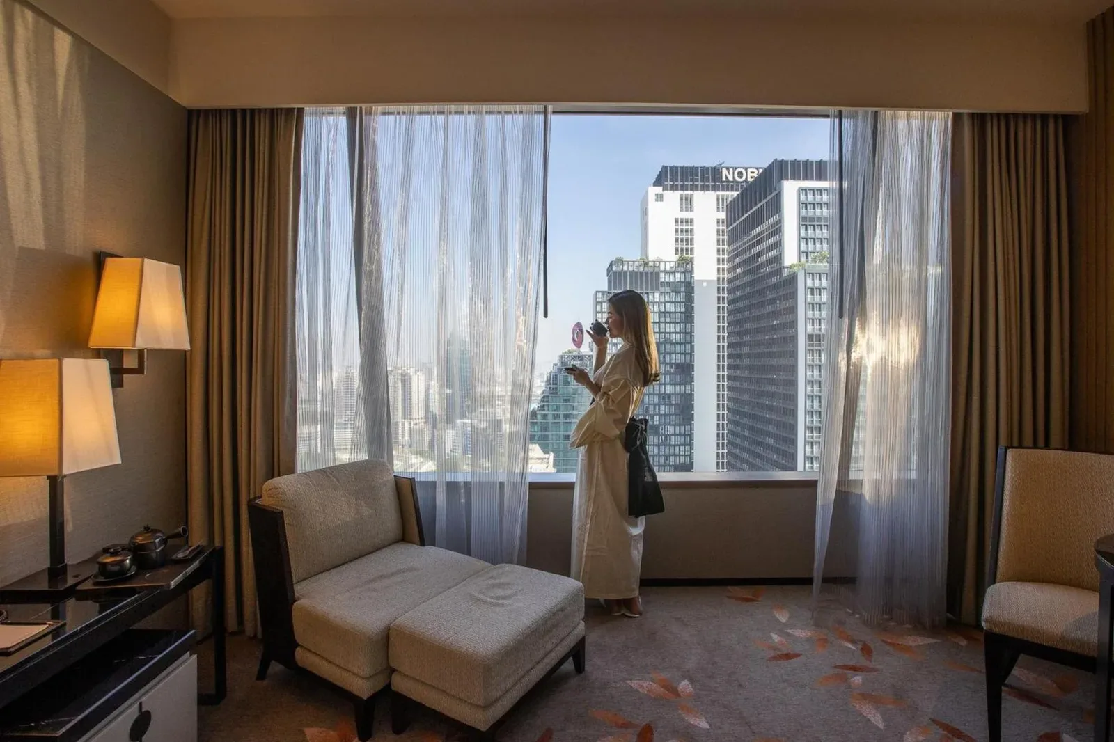 Guest enjoying city view at The Okura Prestige Bangkok