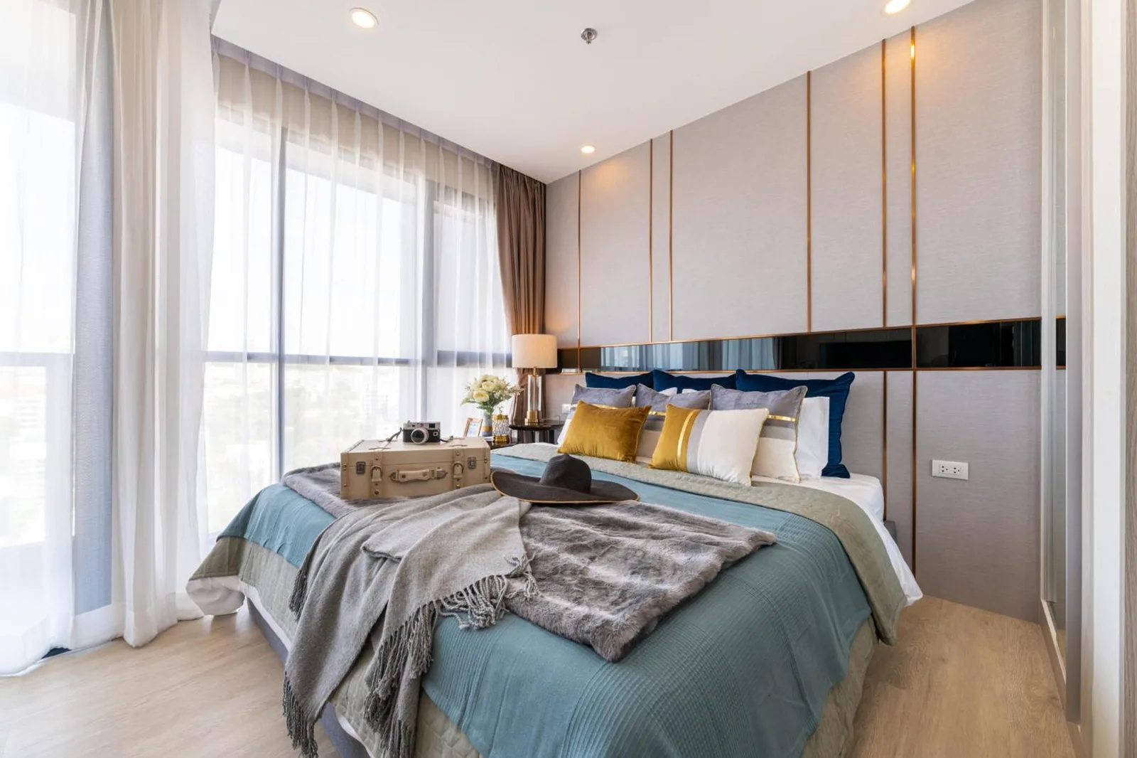 Stylish bedroom at The Panora Pattaya by PH with large windows and modern decor in Pattaya
