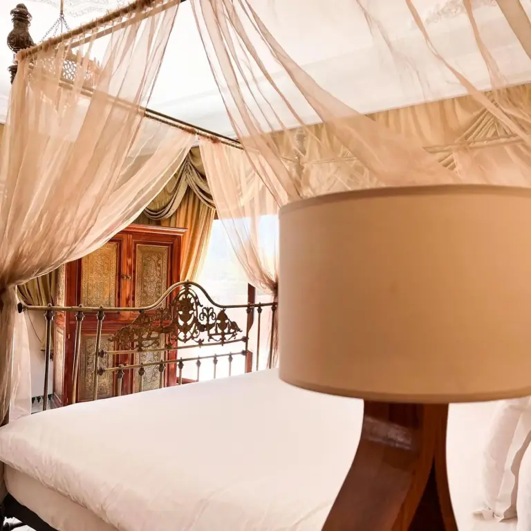 The Red House Marrakech canopy bed with elegant drapery