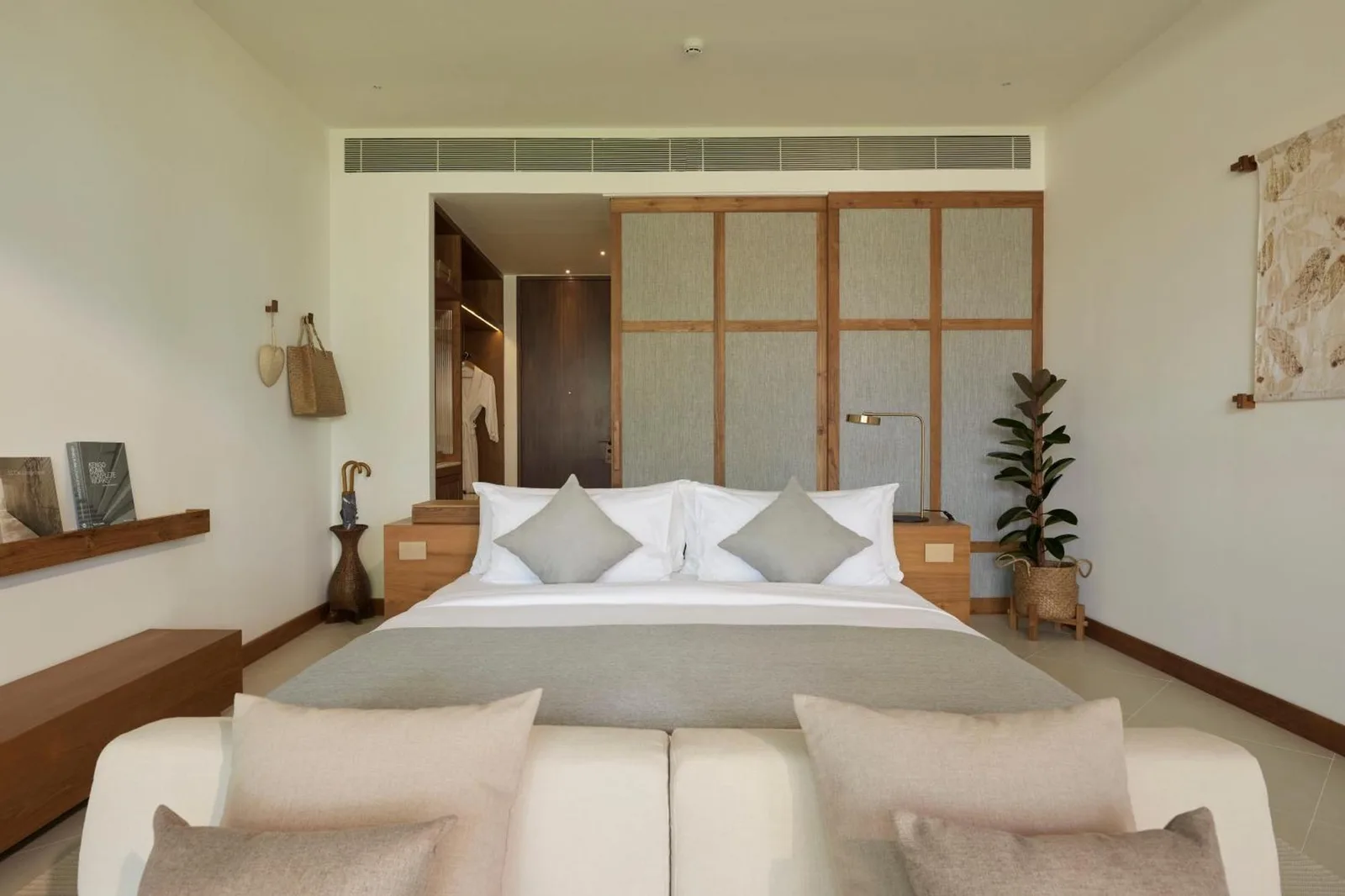 A cozy and elegant bedroom at The Retreat Koh Chang, an SLH Hotel, with modern amenities.