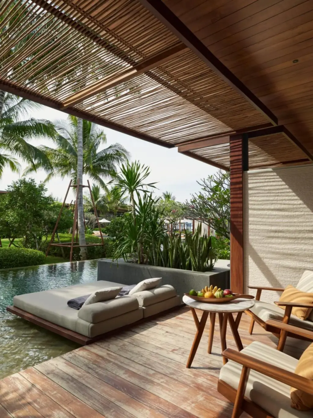 A private lounge area with sunbeds at The Retreat Koh Chang, an SLH Hotel, overlooking the pool.