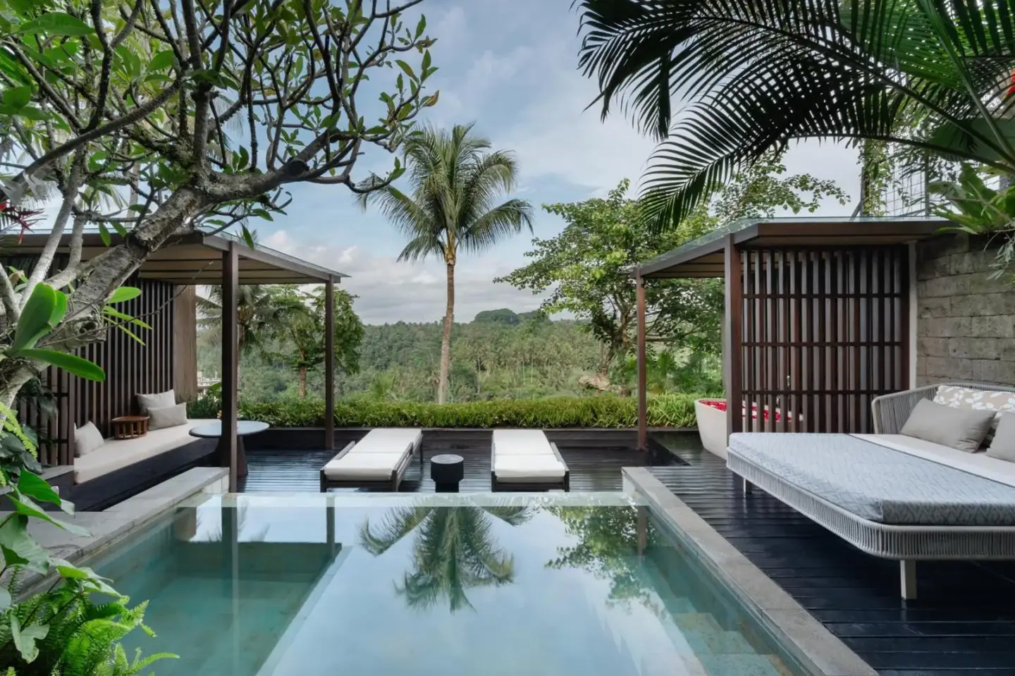 The Ridge Bali private pool area with loungers and lush greenery