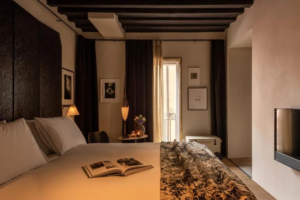 Guest room and bathroom area at The Venice Venice Hotel in Venice