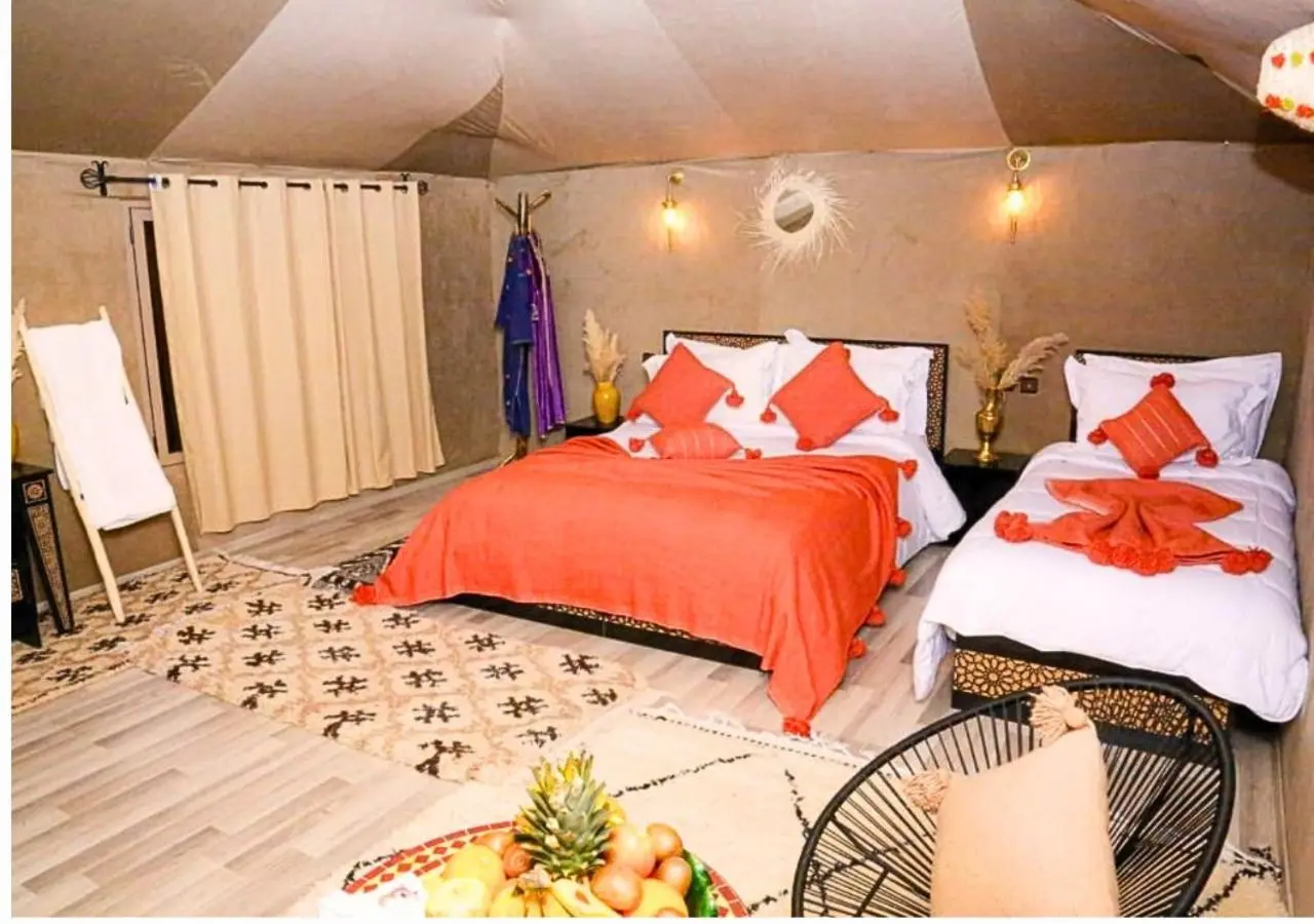 Cozy tent room at Tinariwen Luxury Camp in Merzouga
