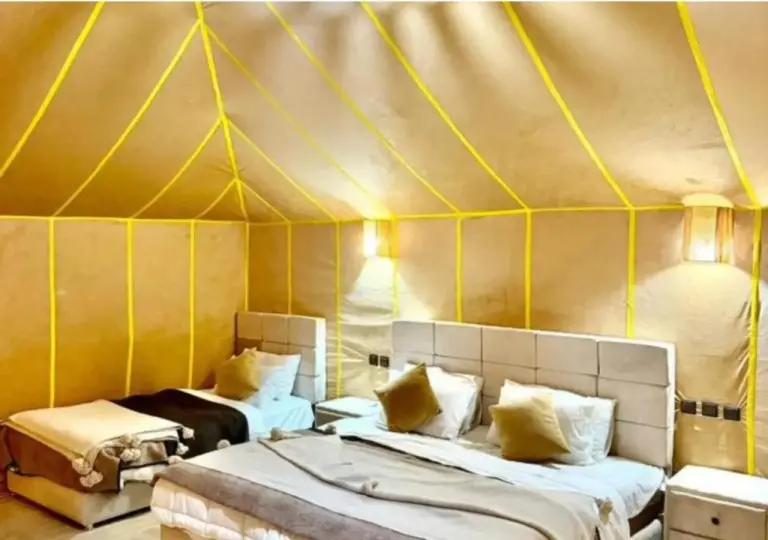 Deluxe tent interior at Tinariwen Luxury Camp in Merzouga