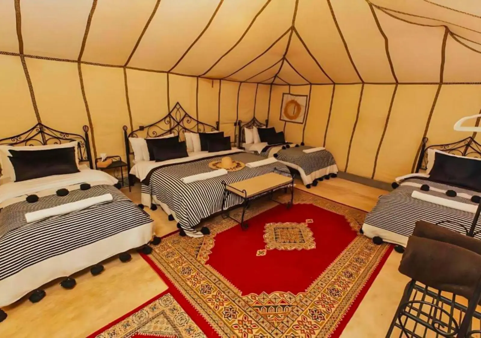 Elegant tent interior at Tinariwen Luxury Camp in Merzouga
