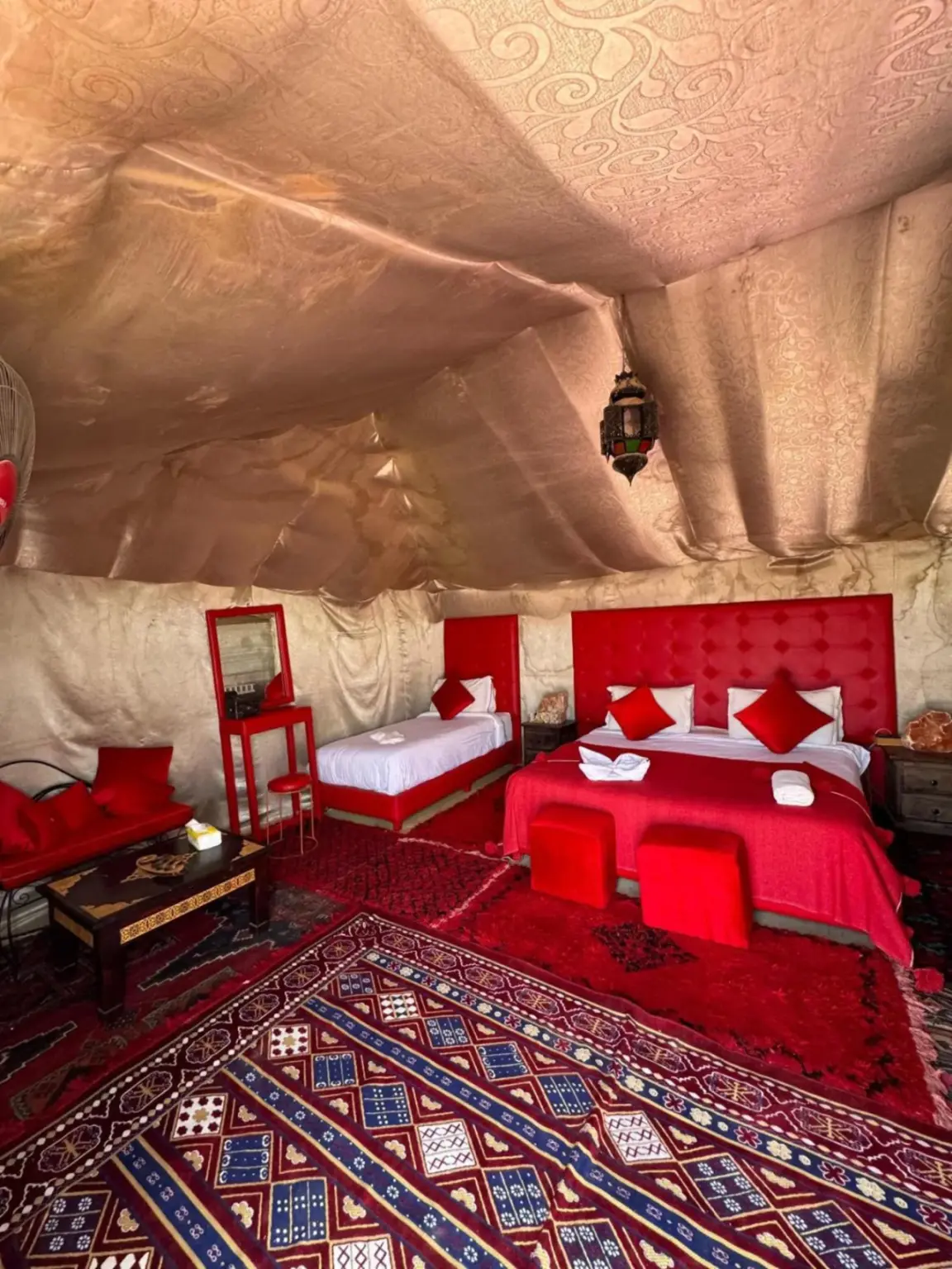 Decorative bathroom sink and mirror inside Tudert Luxury Camp in Merzouga