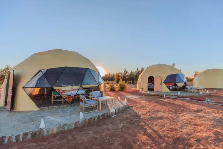 Unique Desert Camp in Merzouga exterior tents at sunset