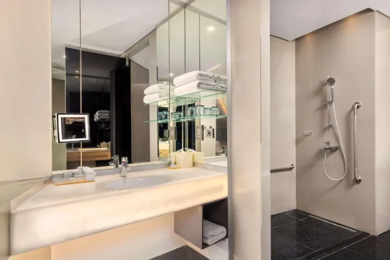 Baño moderno del V Hotel Dubai con acentos de vidrio