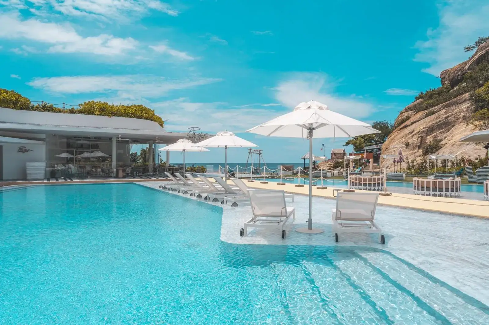 VERSO Hua Hin swimming pool with sun loungers and ocean view