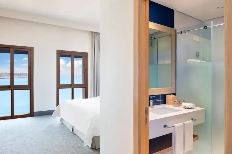 Modern bathroom vanity and shower at Vida Beach Resort Umm Al Quwain with glass partition