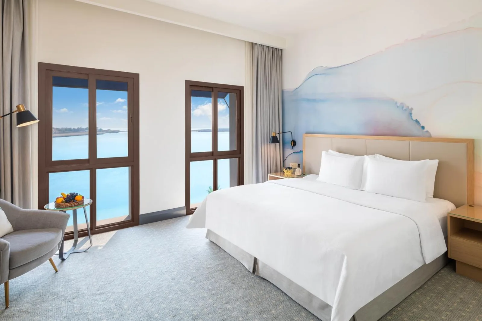 King bed sea view room at Vida Beach Resort Umm Al Quwain with ocean-facing windows
