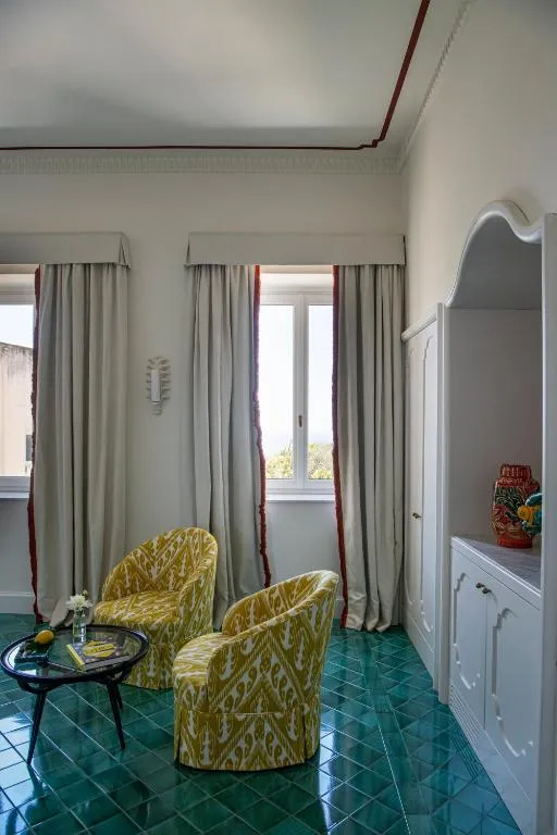 Charming sitting area in a guest room at Villa Helios Capri
