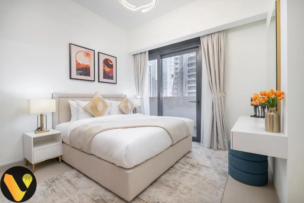 Cozy bedroom at Vogue Vacation Homes with city view