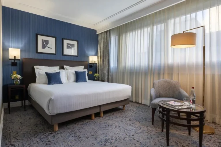 Bedroom view of a Deluxe Room at Warwick Paris Champs-Elysées