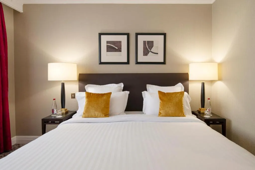 Double bed in a room at Warwick Paris Champs-Elysées