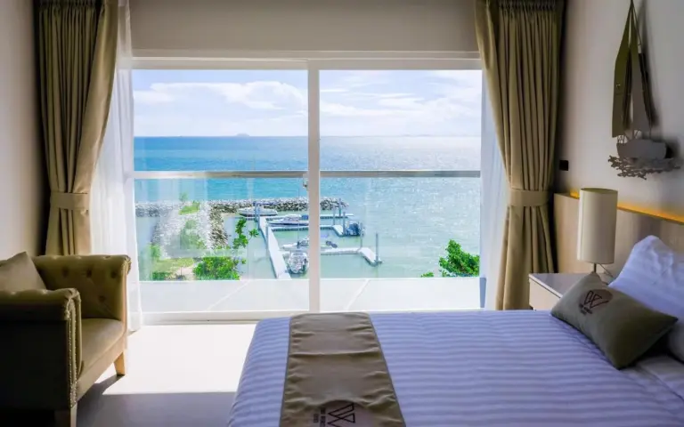 Family room at Worita Cove Hotel Pattaya with bunk bed, dining table, and kitchenette.