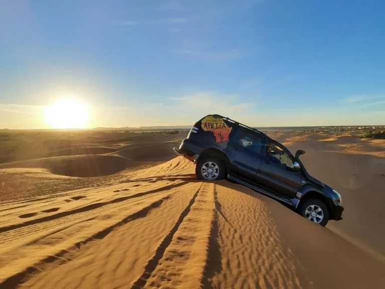 SUV navigating dunes at Your Magic Camp in Merzouga